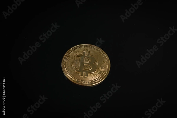 Fototapeta Gold coin of digital currency on a black background.