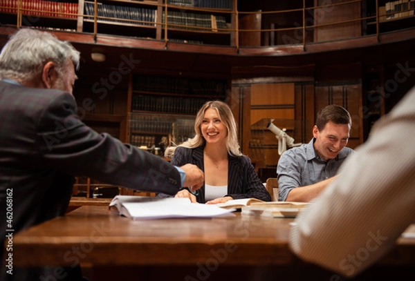 Fototapeta Students preparing exam and learning lessons in school library