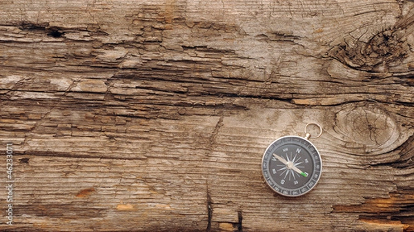 Fototapeta Compass on the old wooden background