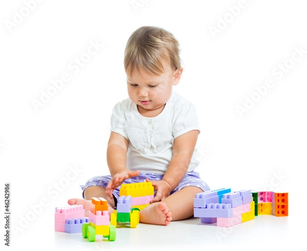 Fototapeta little cheerful child with construction set over white backgroun