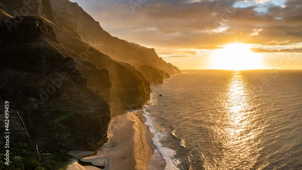 Fototapeta View of the Napali Coastline during sunset  at kalalau beach in Kauai, Hawaii. Peaks can be seen with several ridge lines and the ocean.