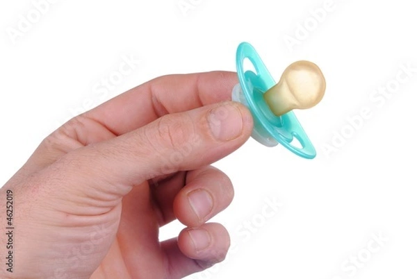 Fototapeta man hand with a baby dummy, isolated on white