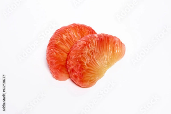 Fototapeta 2 grapefruit peeled, orange-red flesh stacked on a white background