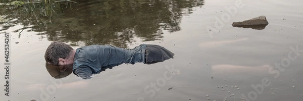 Obraz the body of a man who drowned, lying face down in the water lifeless body