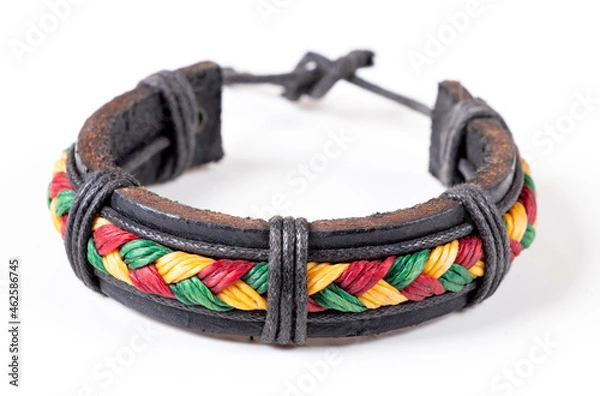 Fototapeta Handmade leather bracelet with colored threads, Thailand. Isolated on white background. Close-up.