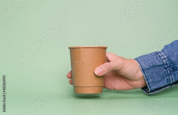 Obraz Hand holding paper cup with copy space.  Recycle and Save the World concept