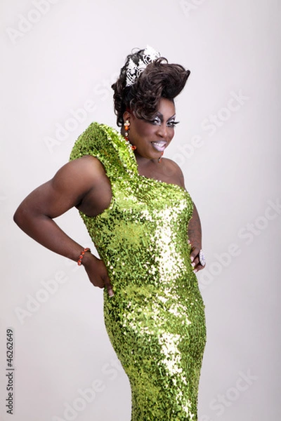 Fototapeta Drag queen wearing a green gown with sequins.