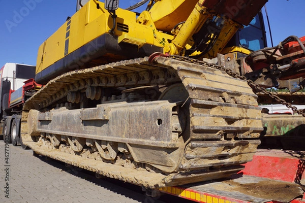 Fototapeta Oversize Load or exceptional convoy (convoi exceptionnel). A truck with a special semi-trailer for transporting oversized loads. Transport of a huge bulldozer.