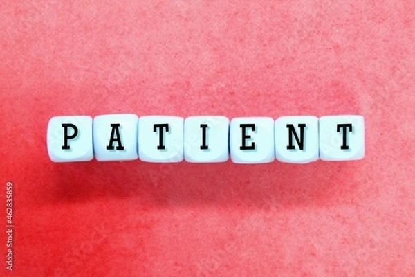 Fototapeta a blue cube with the word PATIENT