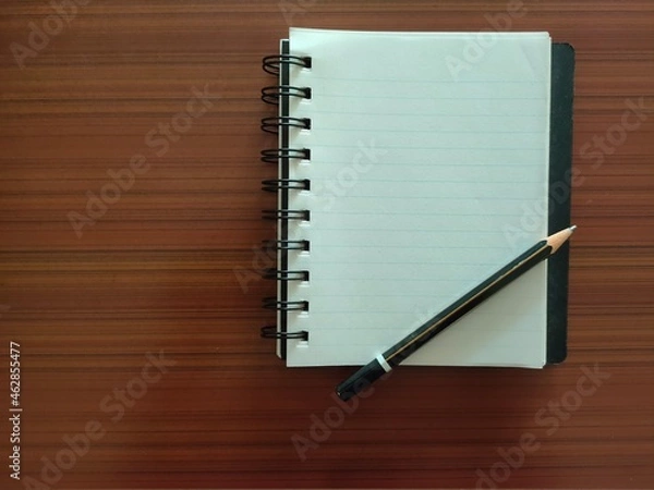 Fototapeta A Notebook with pencil