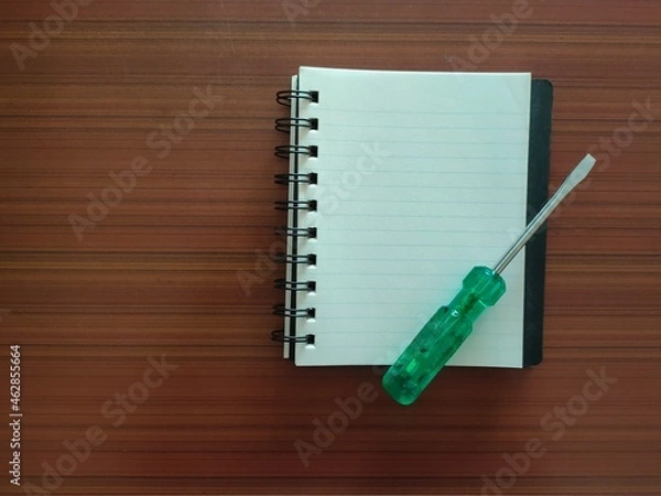 Fototapeta Screwdriver and a notebook