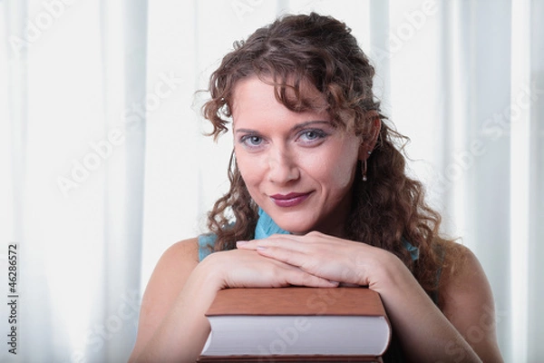 Obraz Young woman with book on white background.