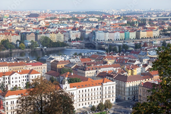 Fototapeta Prague panoramic beautiful panoramic aerial view above of the rooftops. Prague cityscape skyline view at river Vltava and rooftop buildings in Czech Republic.