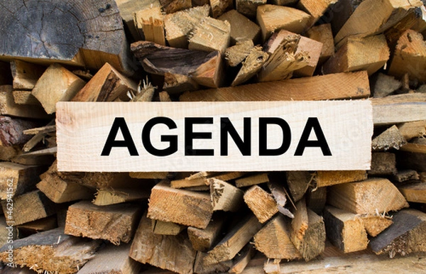 Fototapeta Wall firewood. Background of dry chopped firewood logs in a pile and plate with text Agenda