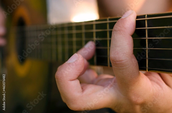 Fototapeta Close up view of man hands playing classical guitar
