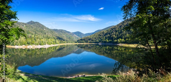 Fototapeta Clear lake with reflections and mountains in background in Vosges, France