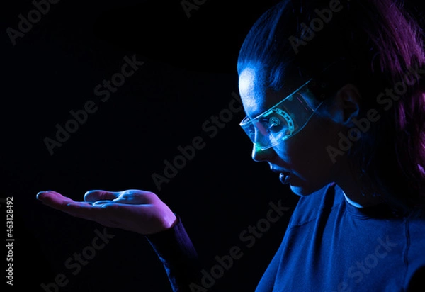 Obraz Concept of future technology or entertainment system, virtual reality. Female portrait lit by HUD interface