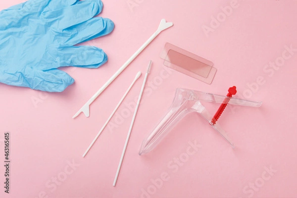 Fototapeta preventive gynecological examination. Prevention for womens health. Basic set for vaginal examination on pink background. Gynecological speculum,  gloves, diaper and shoe covers. Female health concept