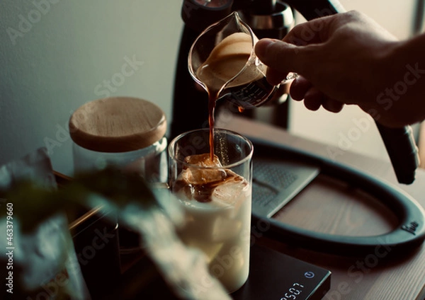 Obraz espresso shot dropping in a glass with digital coffee scale