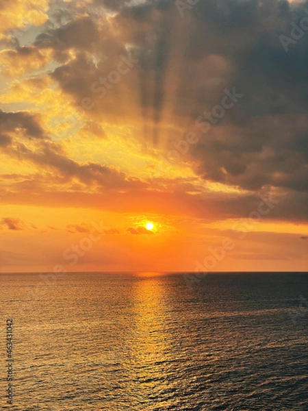 Fototapeta Beautiful sunset with a dramatic sky and clouds over the sea