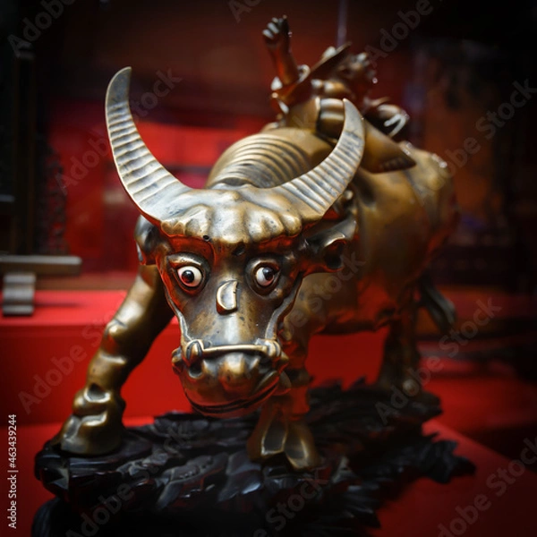 Fototapeta A fragment of the Chinese bronze sculpture "A boy sitting on a buffalo" of the 17th century, depicting the head of a buffalo