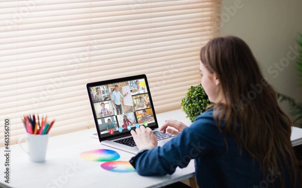 Obraz Caucasian girl using laptop for video call, with smiling diverse elementary school pupils on screen