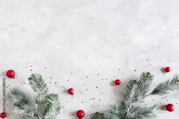 Fototapeta Christmas composition. Fir tree branches, red decorations on gray background. Christmas, winter, new year concept. Flat lay, top view, copy space