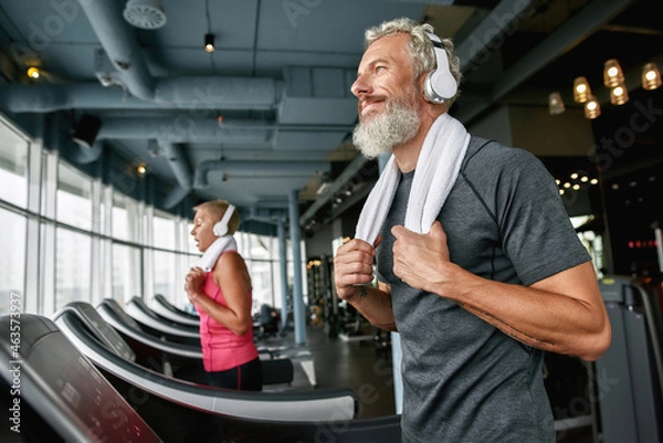 Obraz Happy senior man enjoying excercising in gym