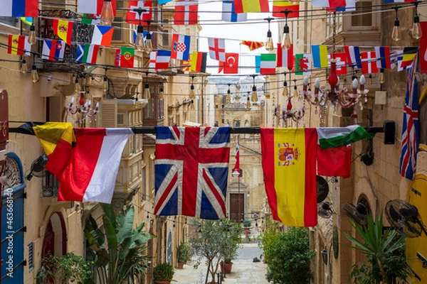 Obraz Flags of various countries hanging over one of the streets in Valletta, Malta.