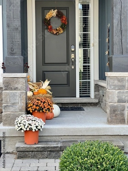 Obraz Colourful pumpkins, gourds and mums create a luxury thanksgiving landscaping decor at a front entrance.