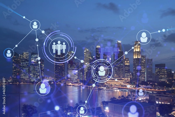 Fototapeta Glowing Social media icons on night panoramic city view of Singapore, Asia. The concept of networking and establishing new connections between people in businesses. Double exposure.