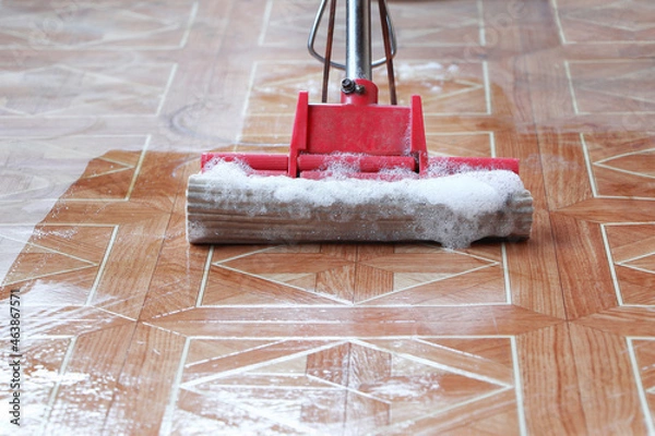 Fototapeta The floor is cleaned with a mop.Foam mop.