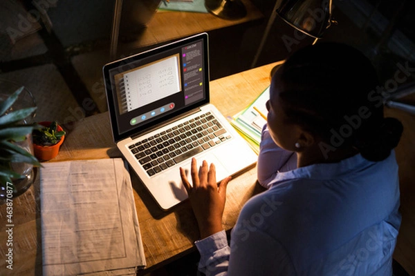 Fototapeta African american woman using laptop for video call, with class on screen