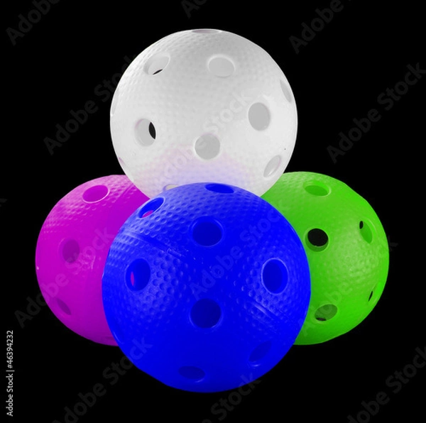 Obraz Four floorball balls isolated on a black background