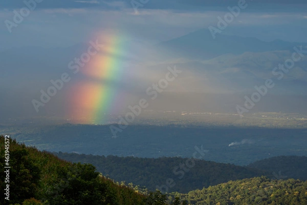 Fototapeta Rainbow over mountain meadow. Rainbow after the rain.