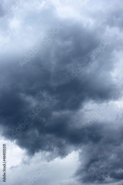 Fototapeta Dark grey threatening thunderclouds, rain clouds in the dark sky, weather change, summer thunderstorms, thunderclouds and rain clouds dark and grey, grey sky