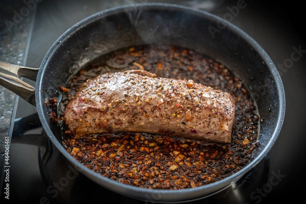 Fototapeta cooking at home - roasted game meat from red deer calf