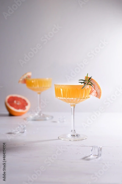 Obraz Two orange coctails and grapefruit on white background