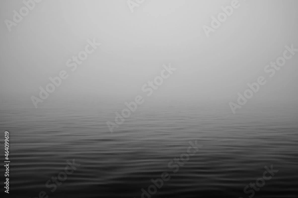 Fototapeta Moving ocean waves in fog black and white. 