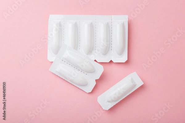 Fototapeta vaginal suppositories on pink background. Top view. Treatment of vaginal infections from sexually transmitted infections. Woman health. Contraception, birth control. Planning pregnancy