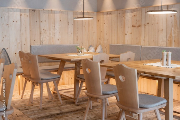 Obraz Newly paneled pine wood seating area with chairs and tables with pleasant, light ceiling lights