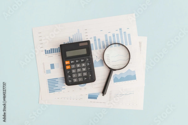 Fototapeta Business graphs, charts, magnifying glass and calculator on table. Financial development, Banking Account, Statistics