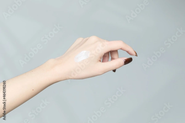 Fototapeta Moisturizing care skincare face cream for healing complicated troubled skin type in an open jar with visible texture. Copy space, close up, background, flat lay, top view. Eucalyptus leaf decoration.