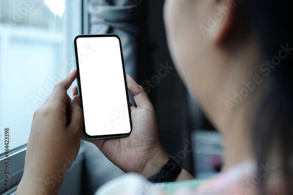 Fototapeta Close up view woman holding mock up smart phone with empty screen