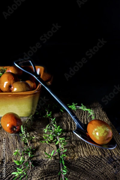 Fototapeta Fresh dates in a plate on a dark background, simple composition, rustic style
