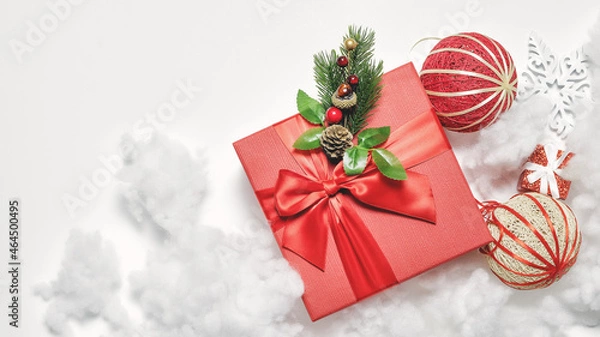 Fototapeta Beautiful Christmas composition with gift box, decorations and artificial snow. Elegant greeting card. Background banner. Festive mockup