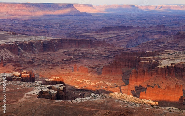 Obraz Desert canyon landscape at sunset, with dramatic rock towers and maze of cliffs extending into the distance. Canyonlands, Utah.