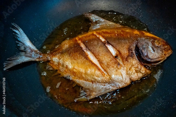 Fototapeta Crispy Fried Pomfret  in the frying pan,  Delicious and healthy