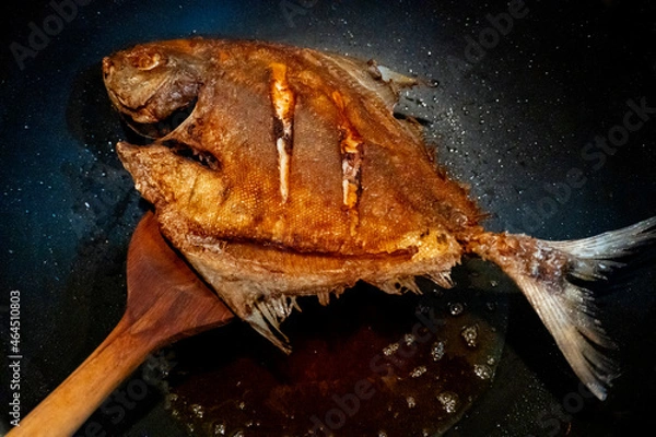 Fototapeta Crispy Fried Pomfret  in the frying pan,  Delicious and healthy