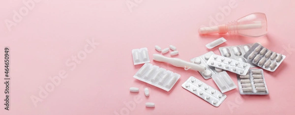 Fototapeta Gynecology concept banner. Vaginal suppositories, enema, tablets, applicator on pink background, treatment of vaginal infections from candidiasis, thrush, sexually transmitted infections. Woman health